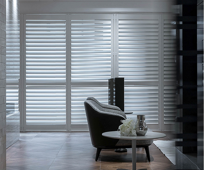 White Shutters in dim room with chair