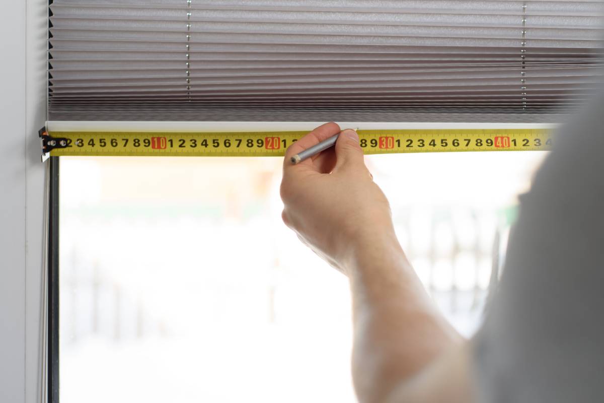 A measuring tape preparing for custom window coverings near Natick, Massachusetts (MA)
