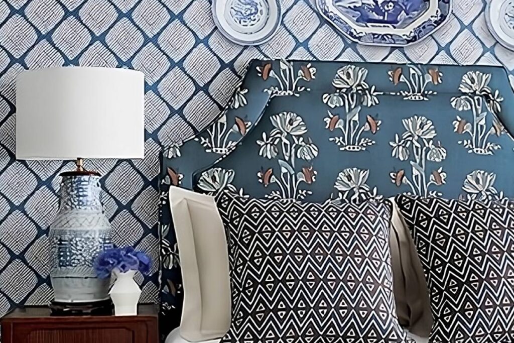 A custom upholstered headboard on a wallpapered wall using Thibaut products near Boston, Massachusetts (MA)